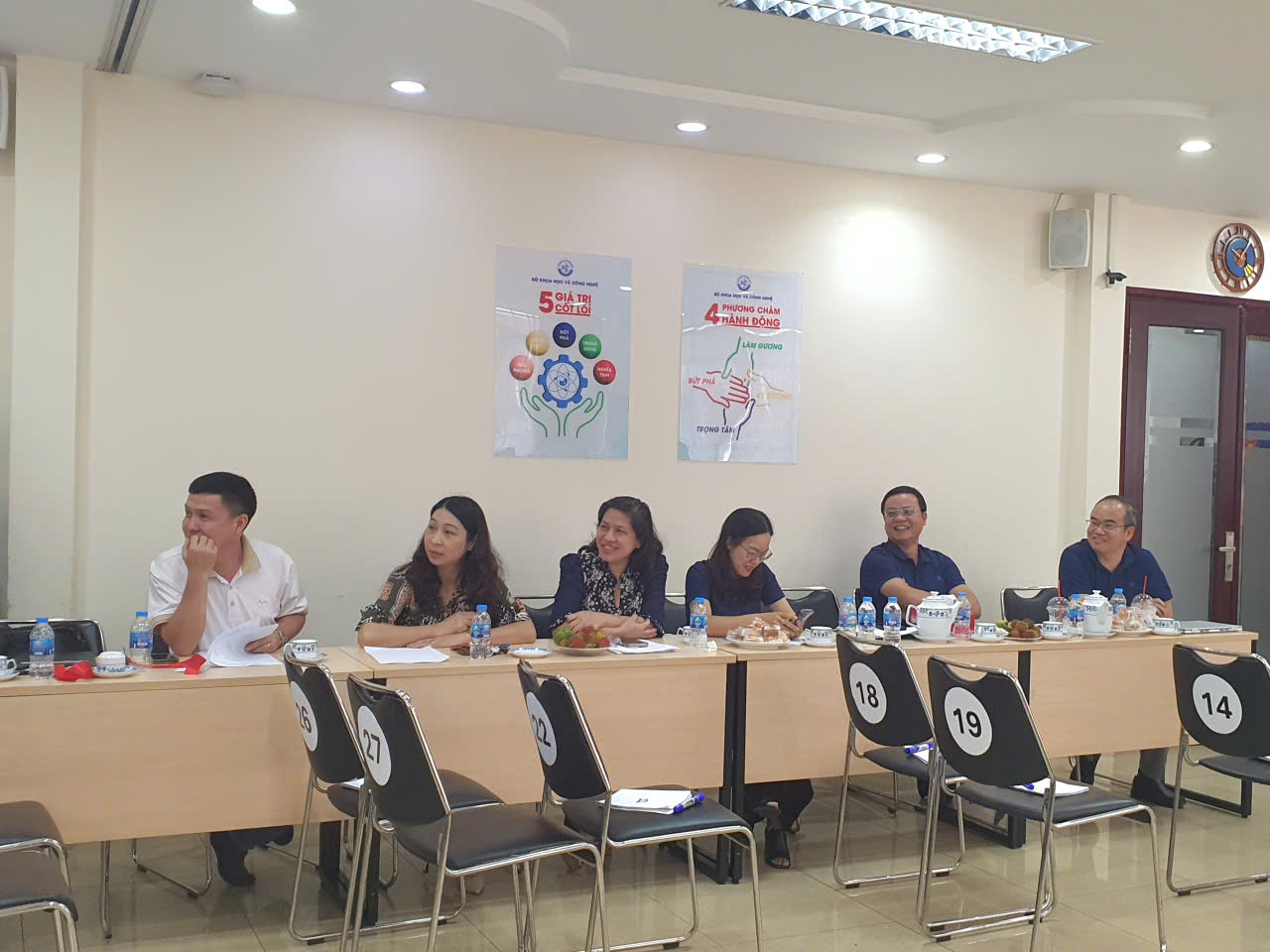 A group of people sitting at a tableAI-generated content may be incorrect.