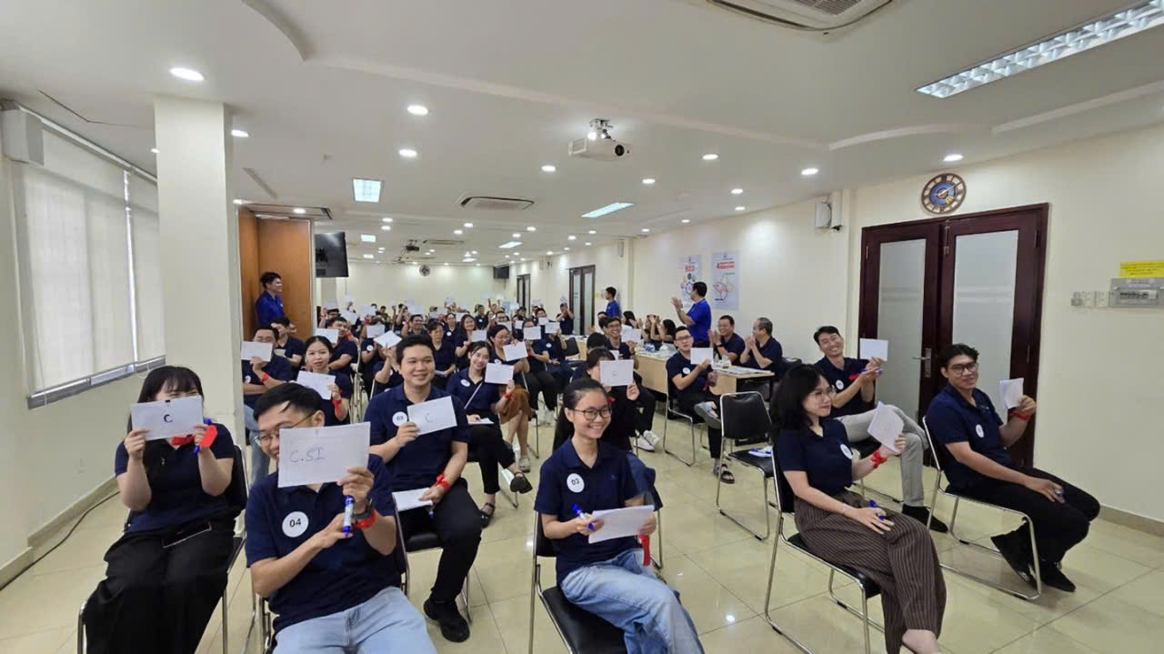 A group of people sitting in chairs holding paperAI-generated content may be incorrect.