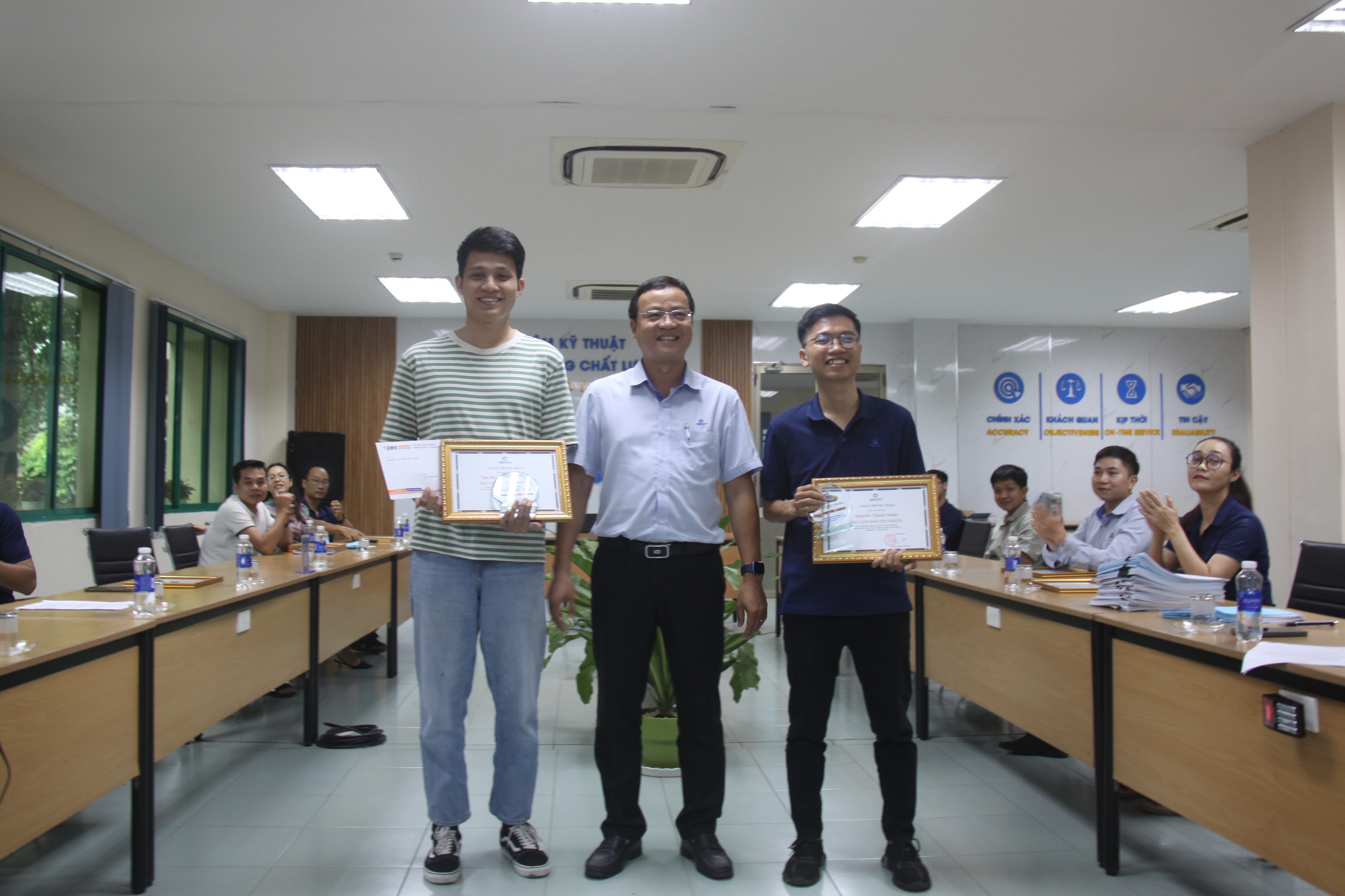 A group of people holding certificatesAI-generated content may be incorrect.